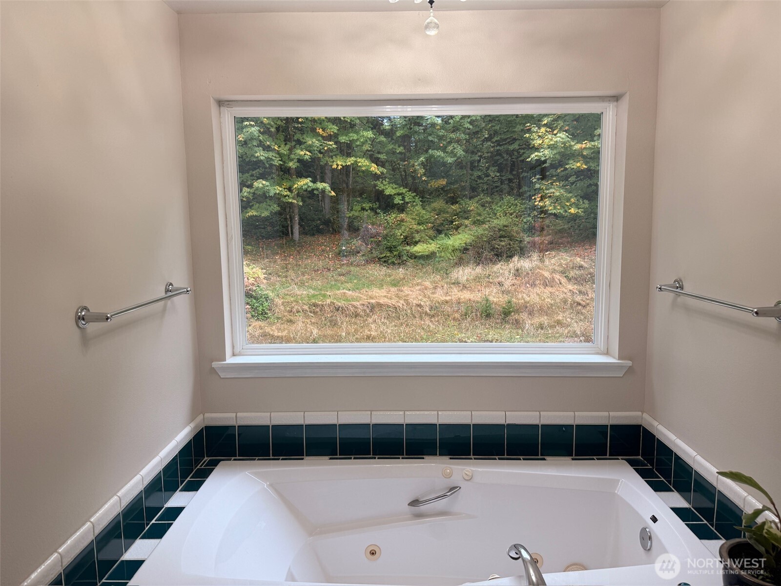 14444 Crescent Valley Road Southeast Olalla, WA 98359 - Photo 16 of 31 a bathroom with a tub and a window