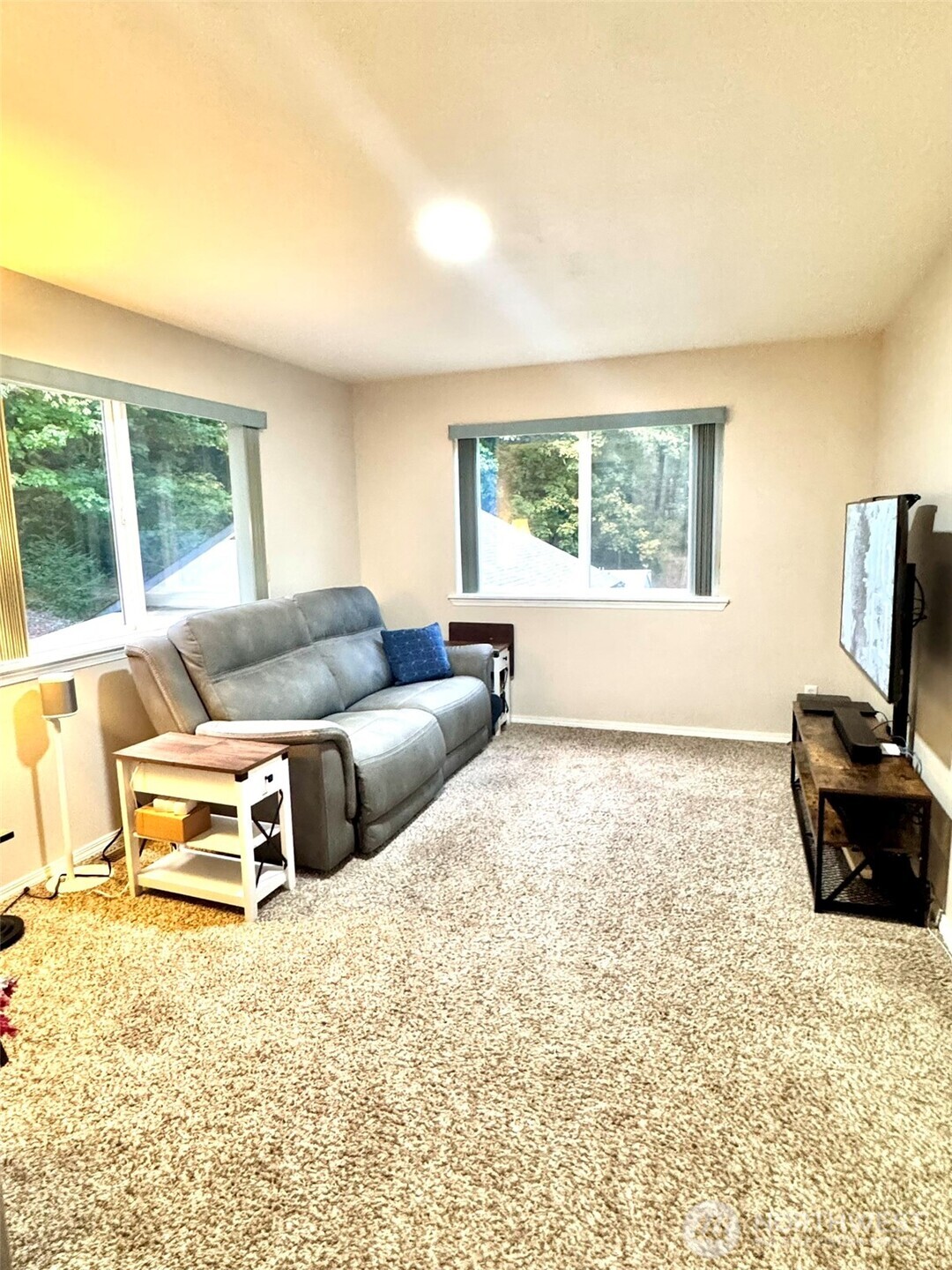 14444 Crescent Valley Road Southeast Olalla, WA 98359 - Photo 17 of 31 a living room with furniture window and a flat screen tv