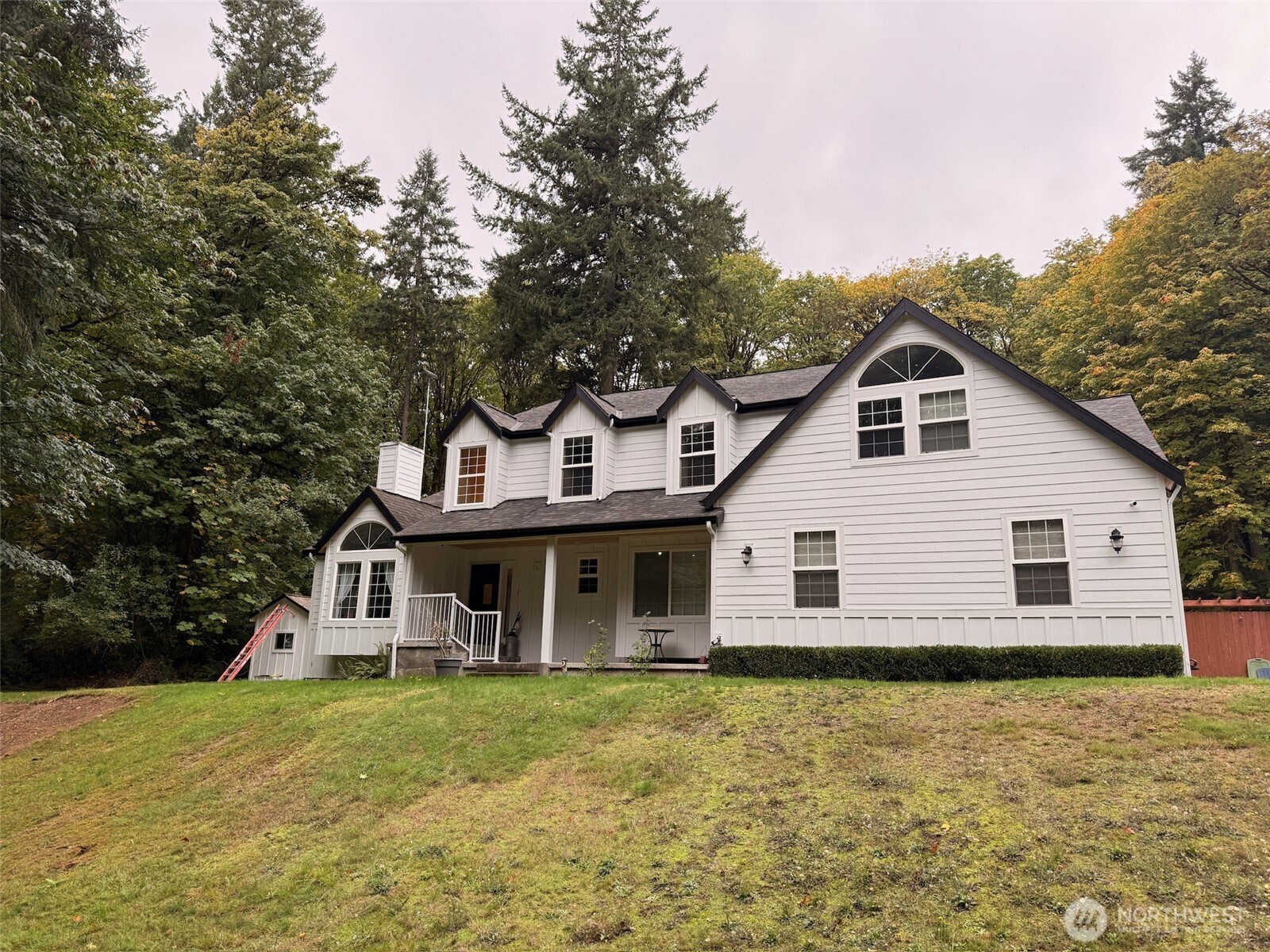 14444 Crescent Valley Road Southeast Olalla, WA 98359 - Photo 3 of 31 a front view of a house with a garden