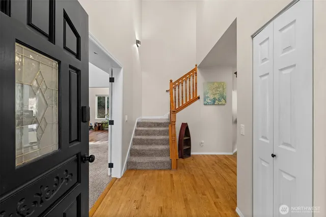 a view of a livingroom with furniture hardwood floor and a window