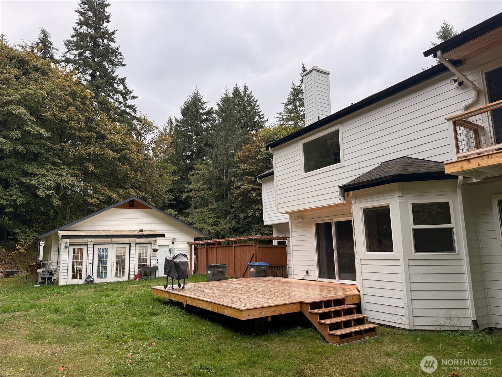 14444 Crescent Valley Road Southeast Olalla, WA 98359 - Photo 6 of 31 a view of a white house with a yard and balcony