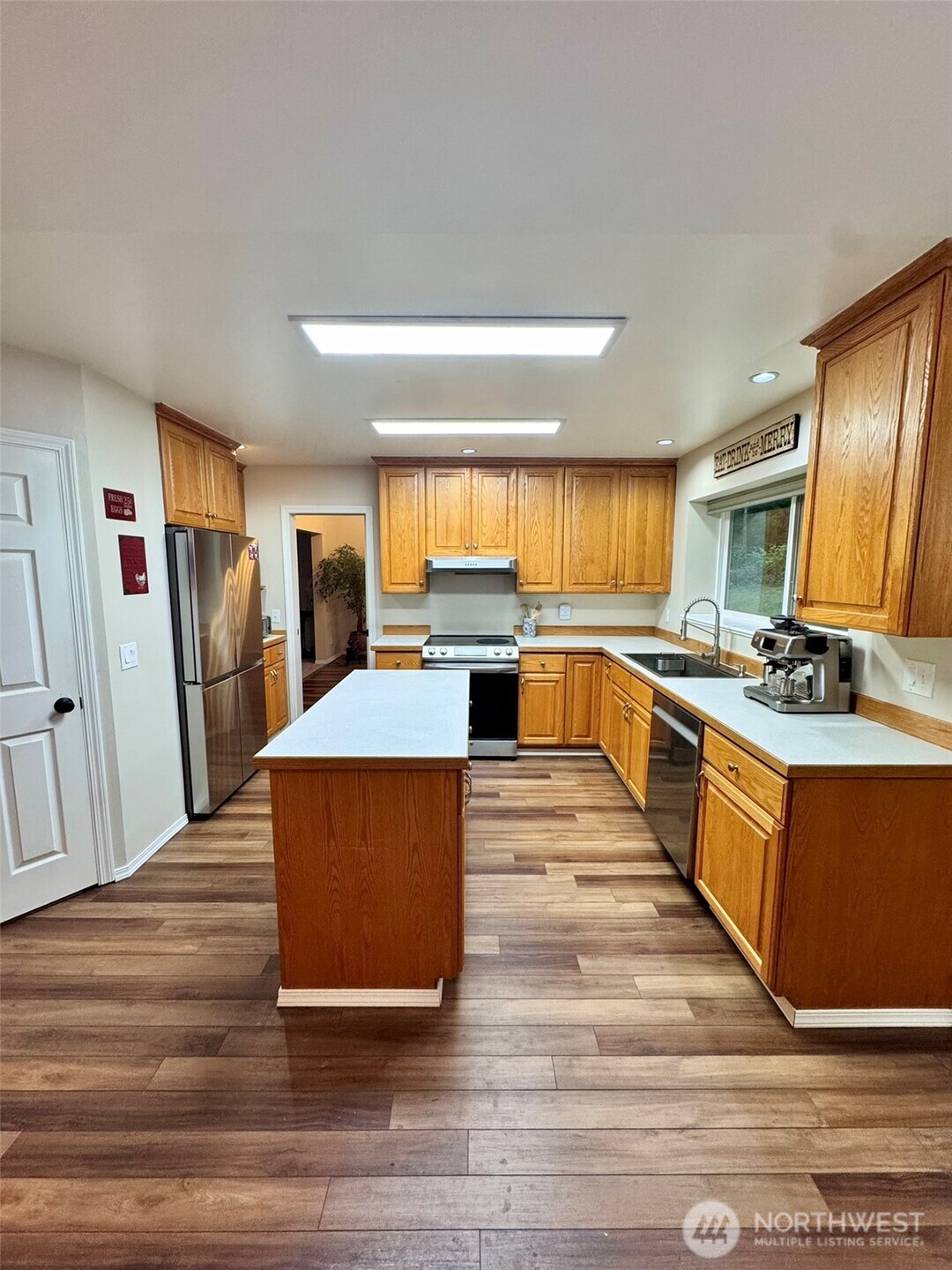 14444 Crescent Valley Road Southeast Olalla, WA 98359 - Photo 8 of 31 a large kitchen with stainless steel appliances a large counter top and a stove