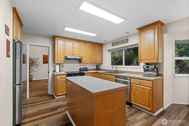 a bathroom with a tub a sink and mirror
