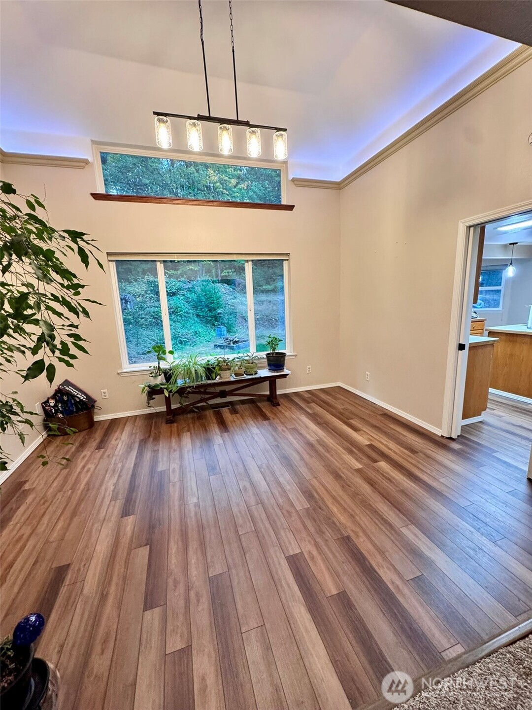 14444 Crescent Valley Road Southeast Olalla, WA 98359 - Photo 10 of 31 a living room with a floor to ceiling window and wooden floor