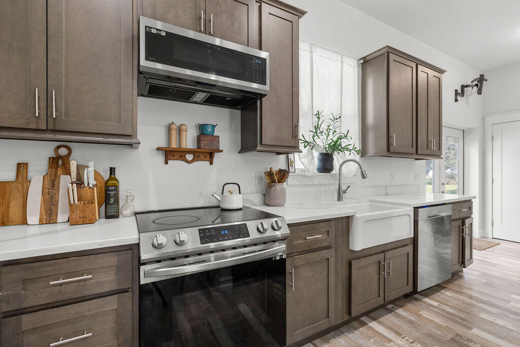 1014 Southwest 11th Street Okeechobee, FL 34974 - Photo 12 of 45 a kitchen with stainless steel appliances granite countertop a sink stove and microwave