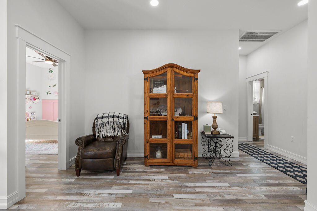 1014 Southwest 11th Street Okeechobee, FL 34974 - Photo 16 of 45 a living room with furniture and a book shelf