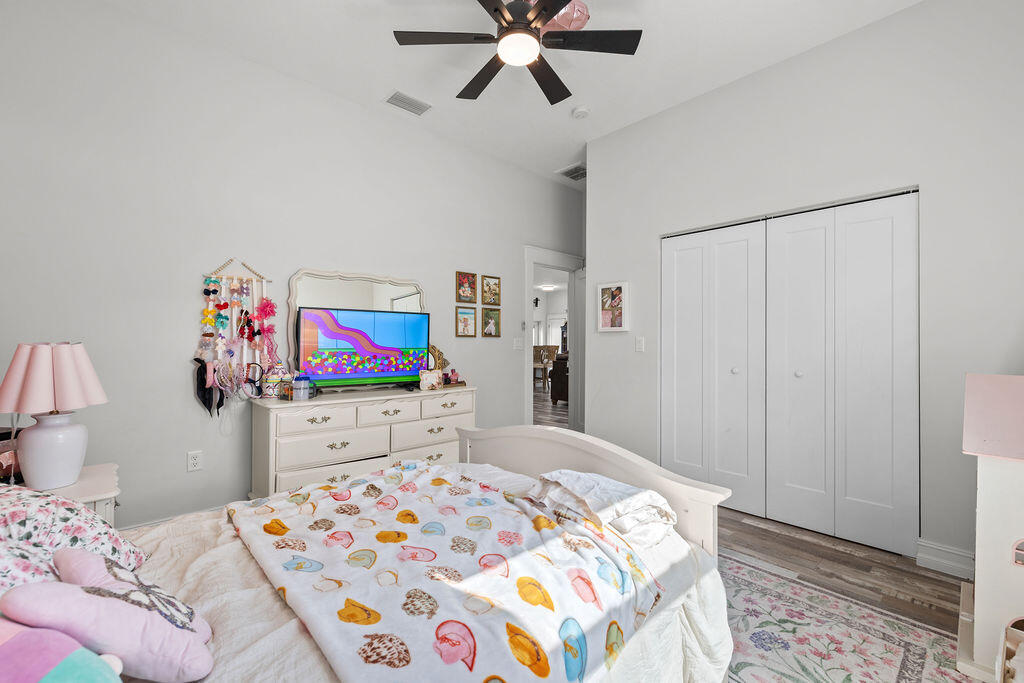 1014 Southwest 11th Street Okeechobee, FL 34974 - Photo 26 of 45 a bedroom with a bed and a dresser in it