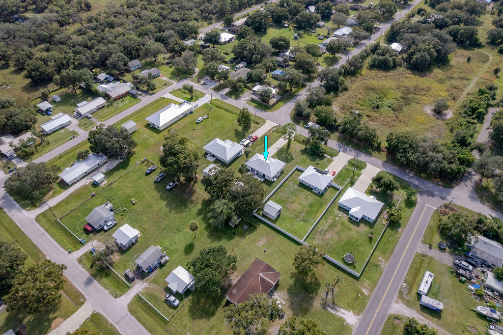 1014 Southwest 11th Street Okeechobee, FL 34974 - Photo 39 of 45 an aerial view of a house a yard and mountain view in back
