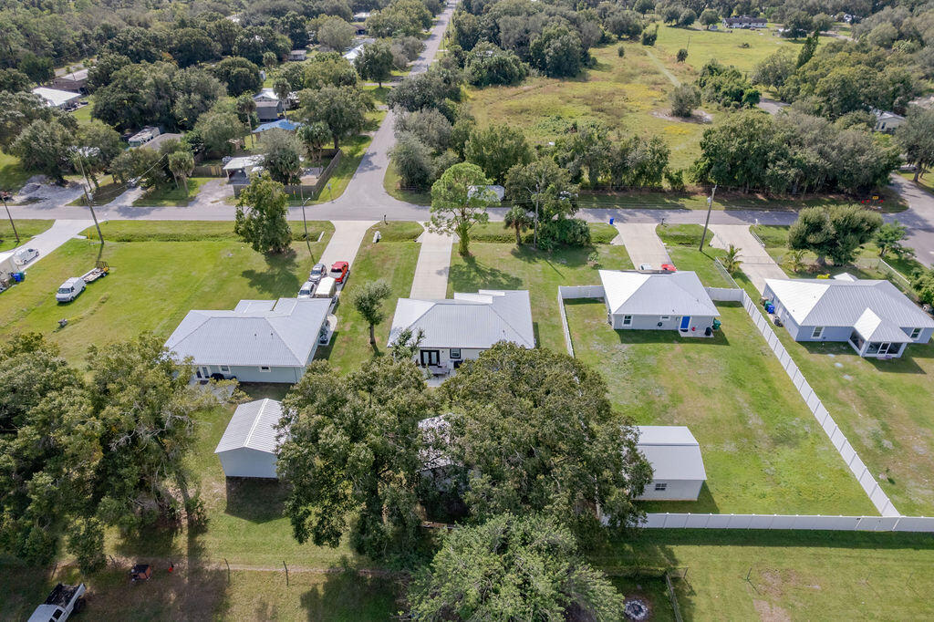 1014 Southwest 11th Street Okeechobee, FL 34974 - Photo 44 of 45 an aerial view of a house with swimming pool and lake view