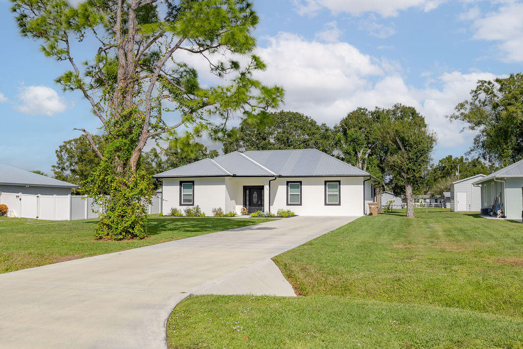 1014 Southwest 11th Street Okeechobee, FL 34974 - Photo 5 of 45 a view of house in front of a big yard with large trees