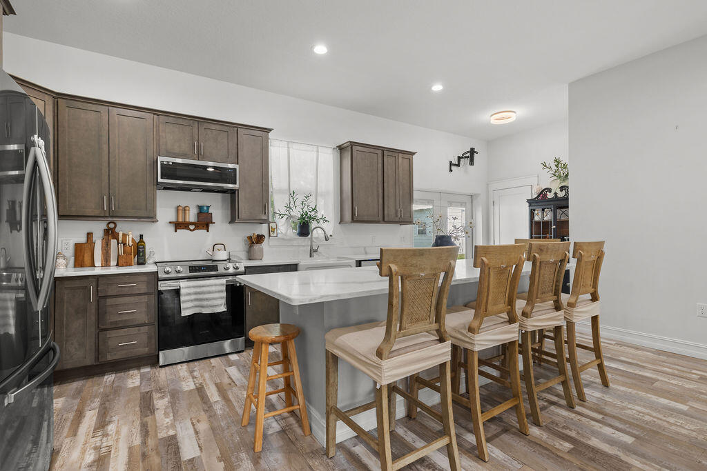 1014 Southwest 11th Street Okeechobee, FL 34974 - Photo 10 of 45 a kitchen with stainless steel appliances kitchen island granite countertop a sink and cabinets