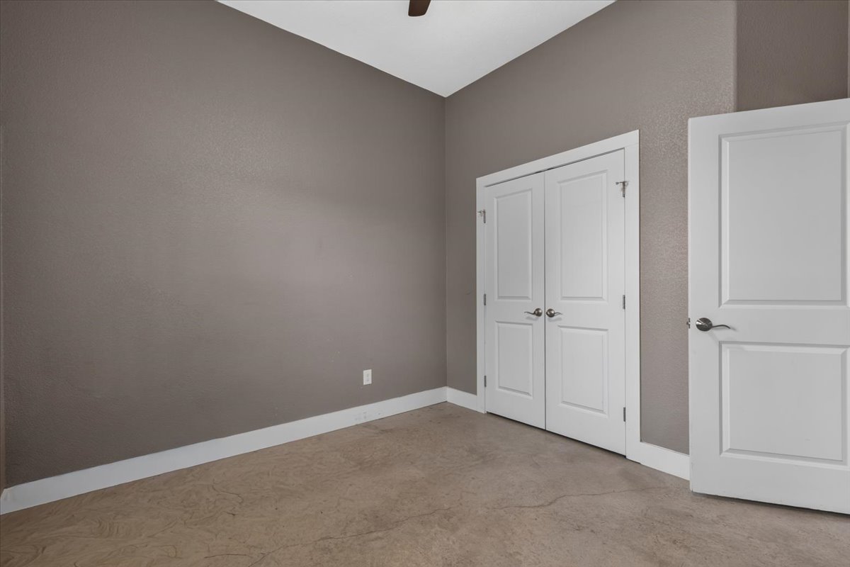 145 Cardinal Loop Paige, TX 78659 - Photo 31 of 40 A well-lit room offers clean lines and durable flooring, with ample closet space.