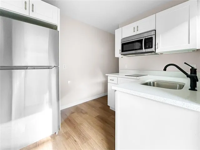 a kitchen with a sink and a microwave