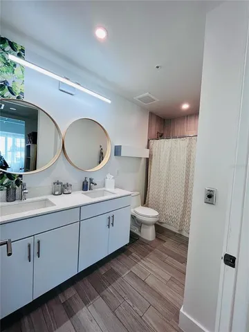 a bathroom with a double vanity sink and a mirror