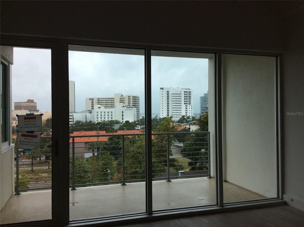 332 Cocoanut Avenue, Unit 507 Sarasota, FL 34236 - Photo 17 of 34 a view of a glass door and chair