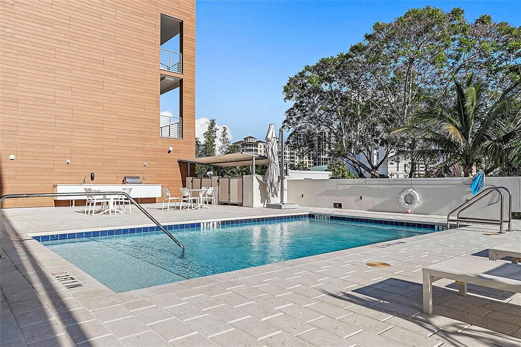 332 Cocoanut Avenue, Unit 507 Sarasota, FL 34236 - Photo 20 of 34 a view of a swimming pool with a patio