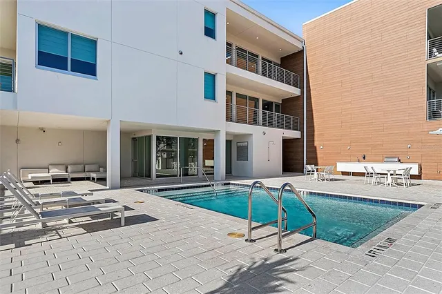 a view of a building with backyard and sitting area