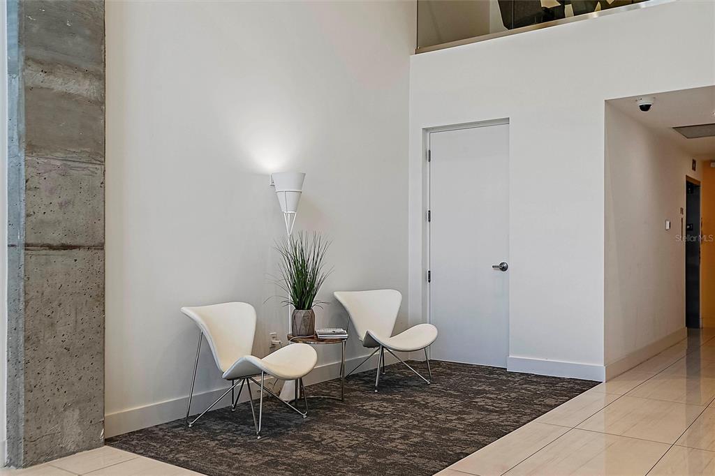 332 Cocoanut Avenue, Unit 507 Sarasota, FL 34236 - Photo 25 of 34 a bathroom with a toilet a chair and a potted plant