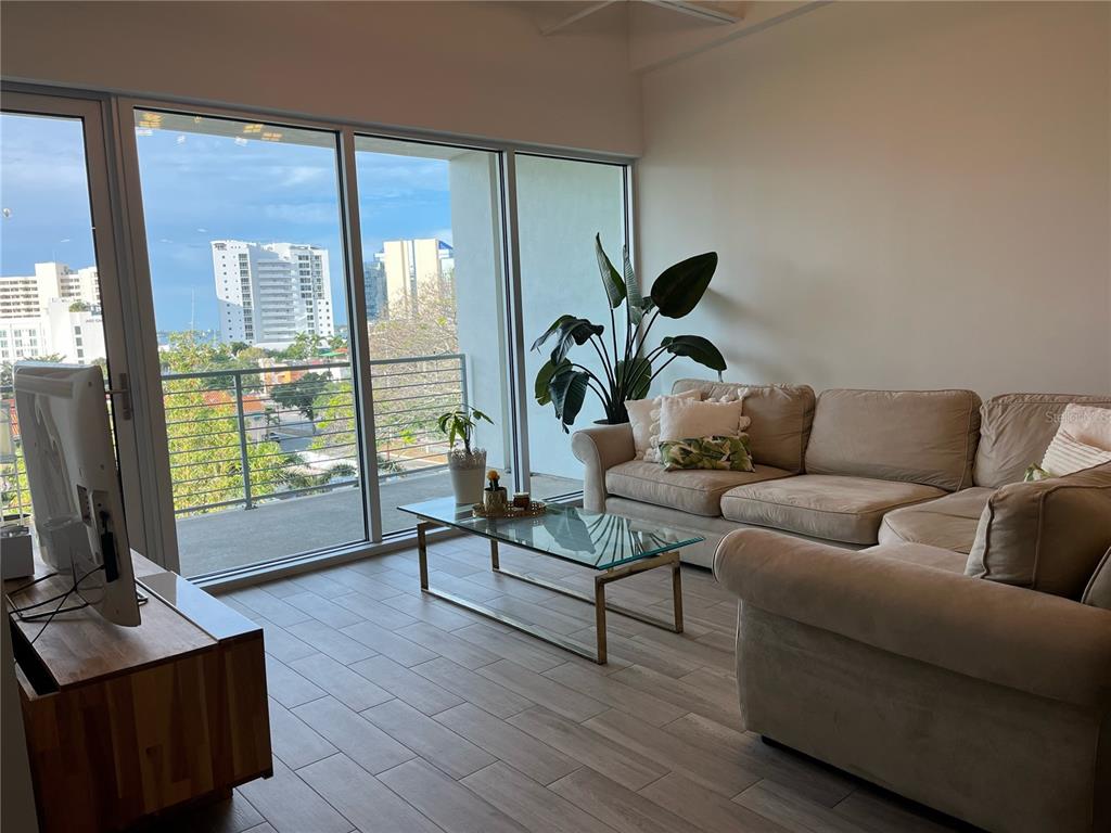 332 Cocoanut Avenue, Unit 507 Sarasota, FL 34236 - Photo 4 of 34 a living room with furniture and a flat screen tv