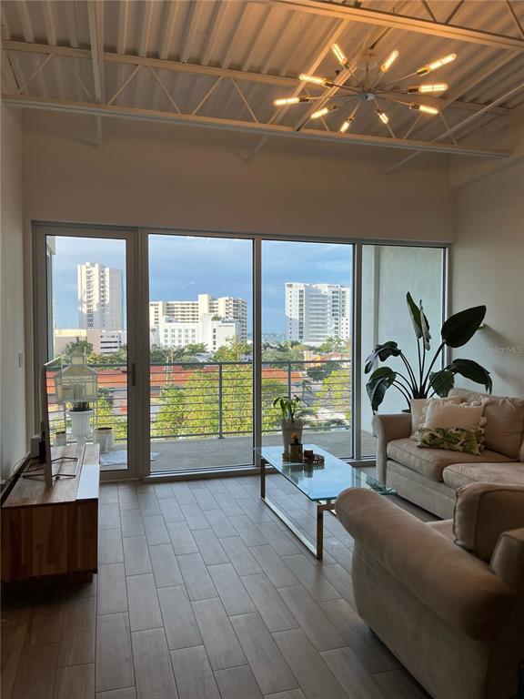 332 Cocoanut Avenue, Unit 507 Sarasota, FL 34236 - Photo 5 of 34 a living room with furniture and a floor to ceiling window
