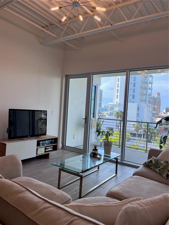 332 Cocoanut Avenue, Unit 507 Sarasota, FL 34236 - Photo 6 of 34 a living room with furniture and a flat screen tv