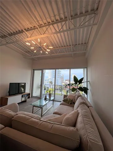 a living room with furniture and a chandelier