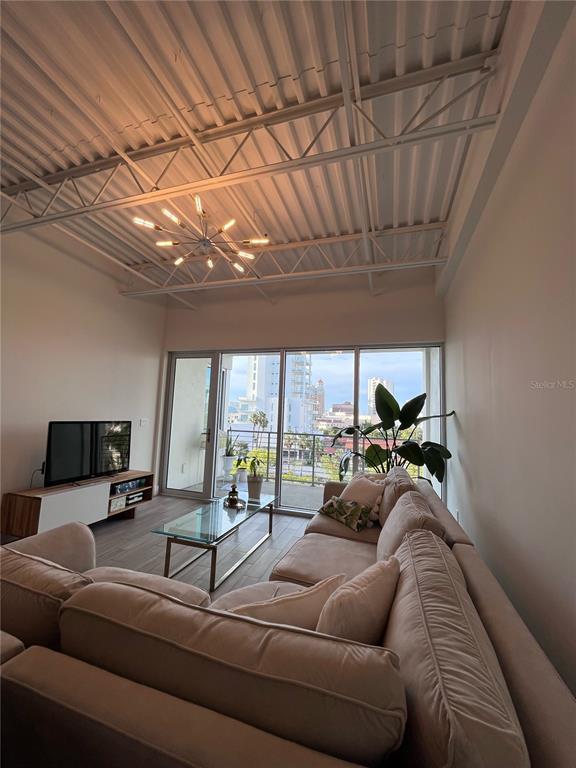 332 Cocoanut Avenue, Unit 507 Sarasota, FL 34236 - Photo 7 of 34 a living room with furniture and a chandelier