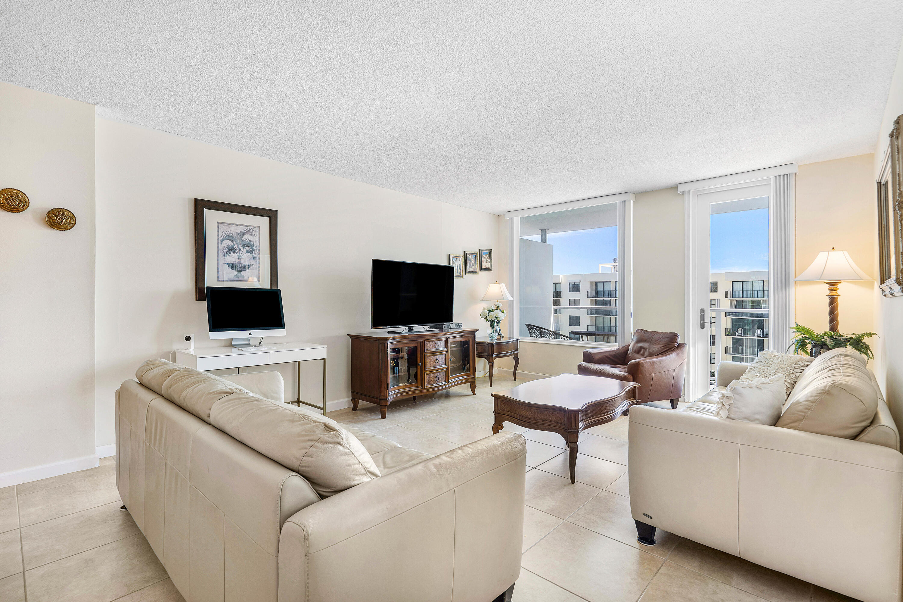 3450 South Ocean Boulevard, Unit 714 Palm Beach, FL 33480 - Photo 11 of 27 a living room with furniture and a flat screen tv