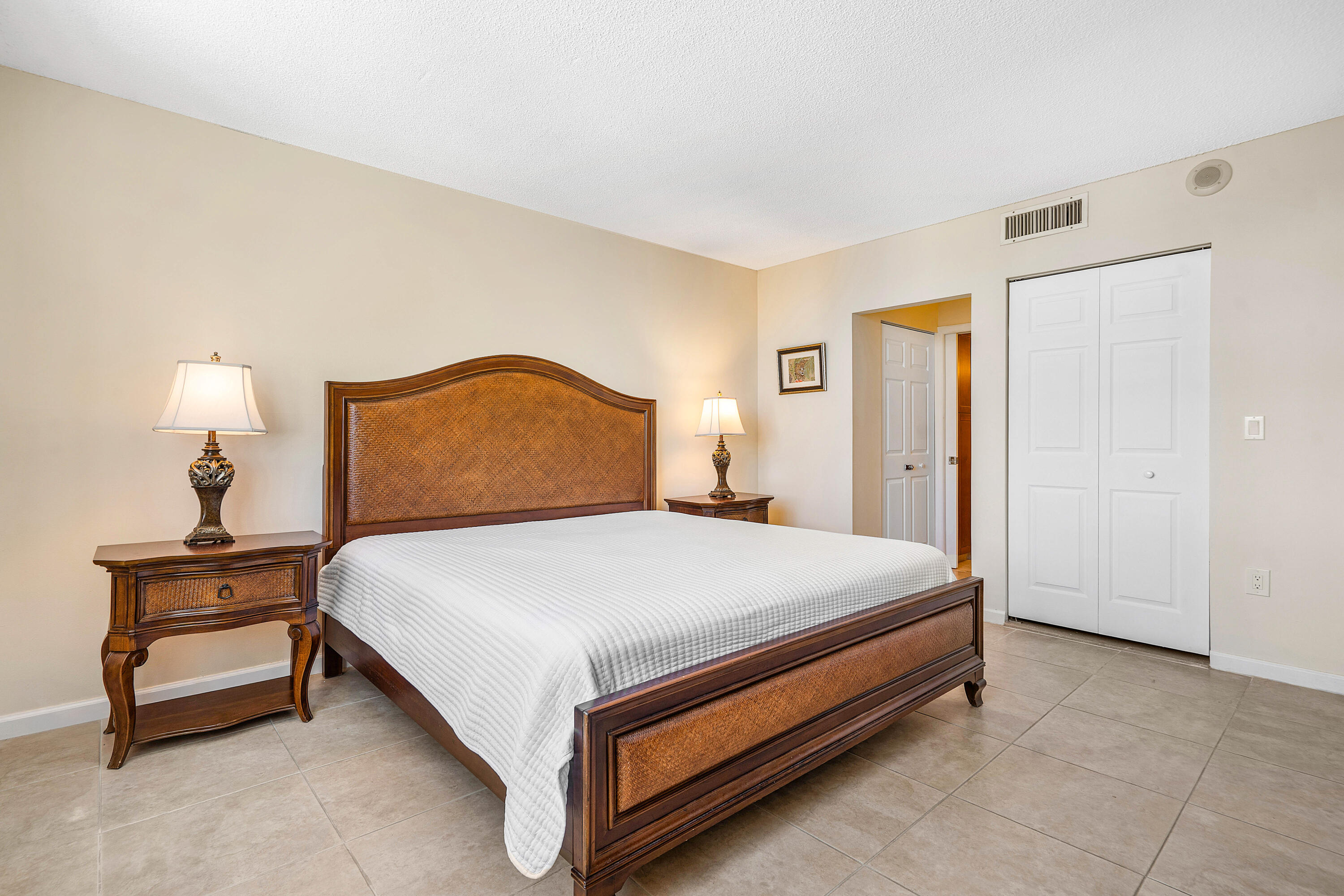 3450 South Ocean Boulevard, Unit 714 Palm Beach, FL 33480 - Photo 16 of 27 a bedroom with a bed and a lamp