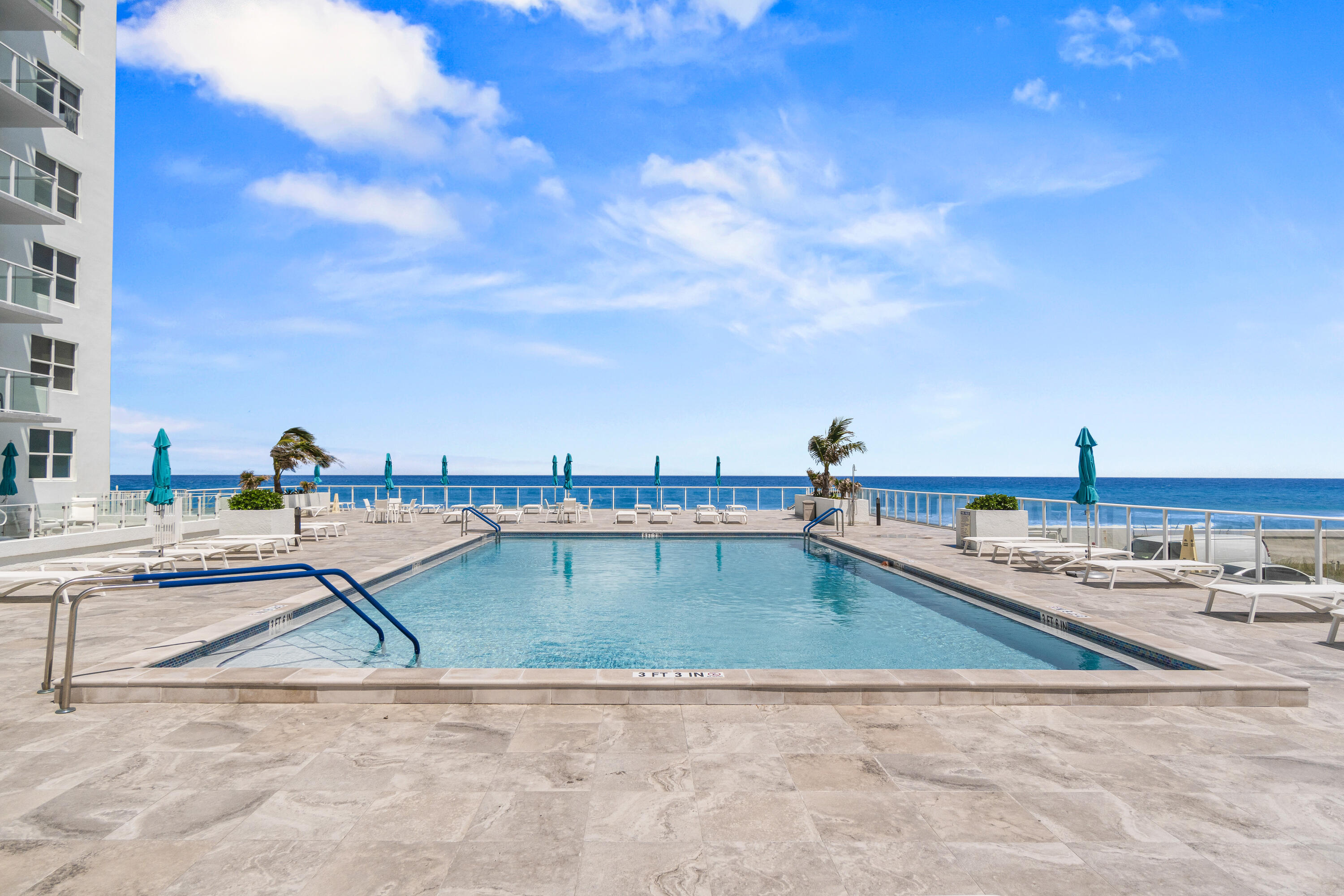 3450 South Ocean Boulevard, Unit 714 Palm Beach, FL 33480 - Photo 26 of 27 a view of a swimming pool with a lounge chairs