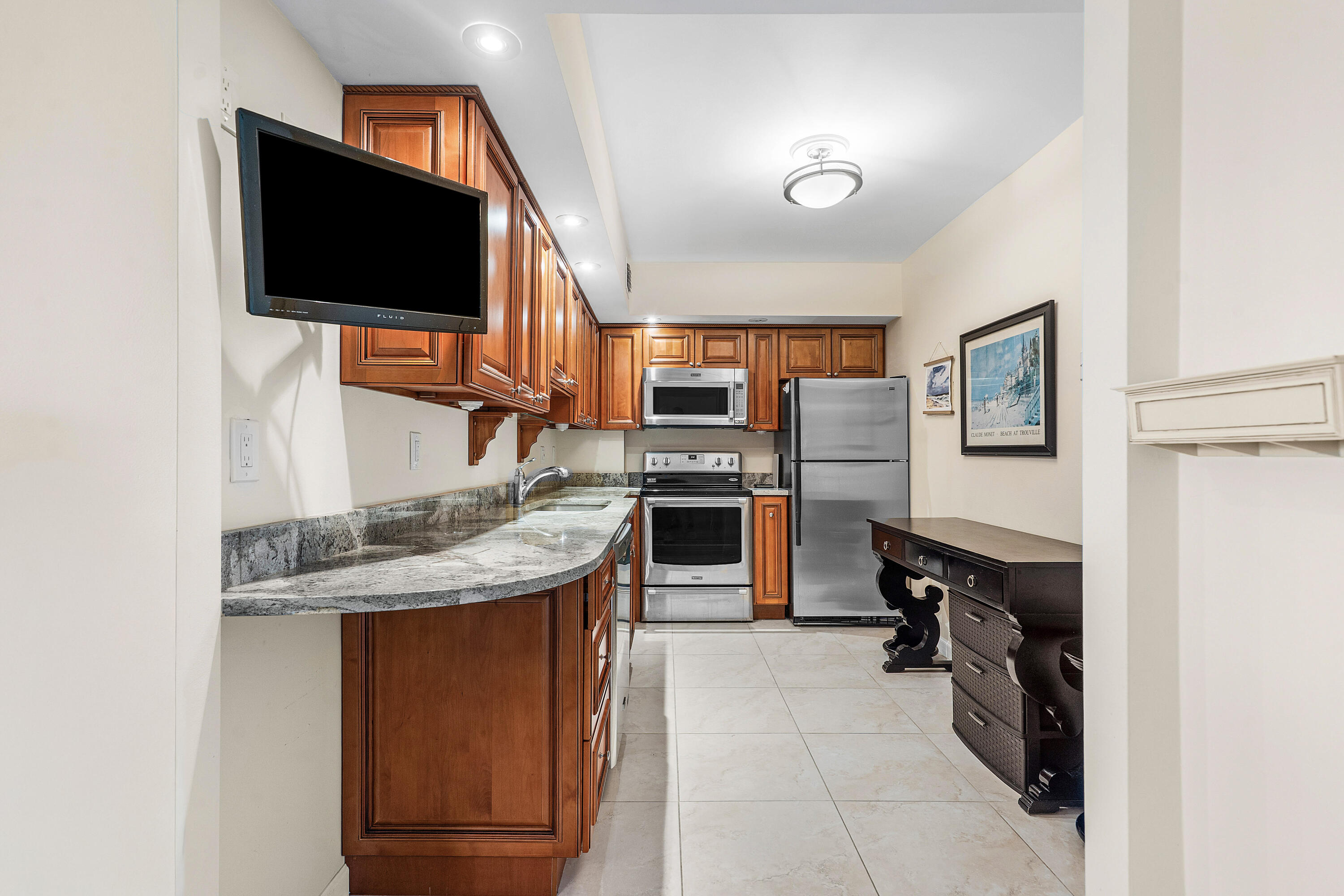 3450 South Ocean Boulevard, Unit 714 Palm Beach, FL 33480 - Photo 4 of 27 a kitchen with stainless steel appliances granite countertop a refrigerator and a stove top oven