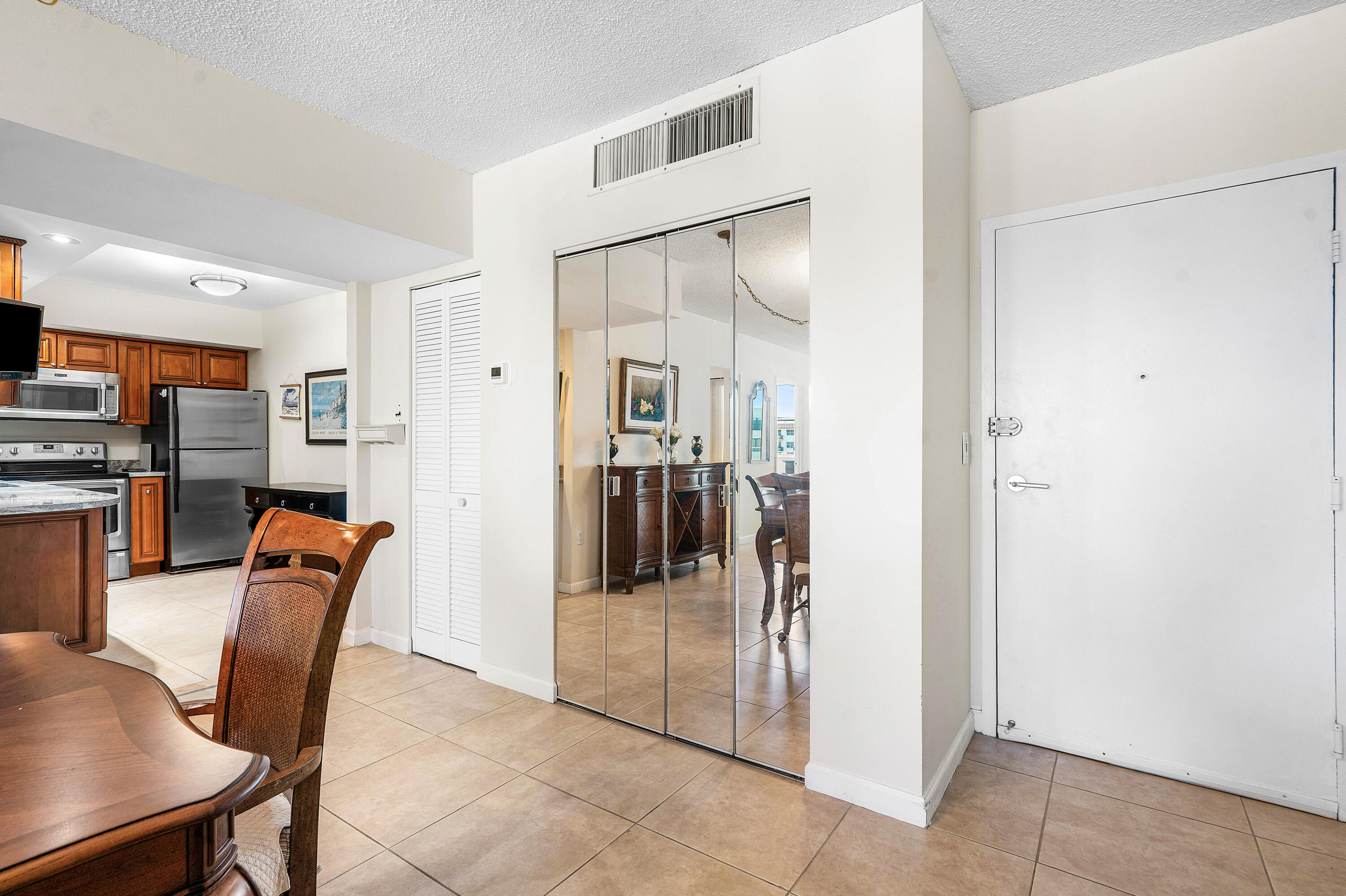 3450 South Ocean Boulevard, Unit 714 Palm Beach, FL 33480 - Photo 7 of 27 a dining room with furniture and a refrigerator