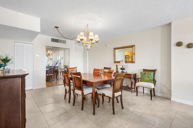 a view of a dining room with furniture and chandelier