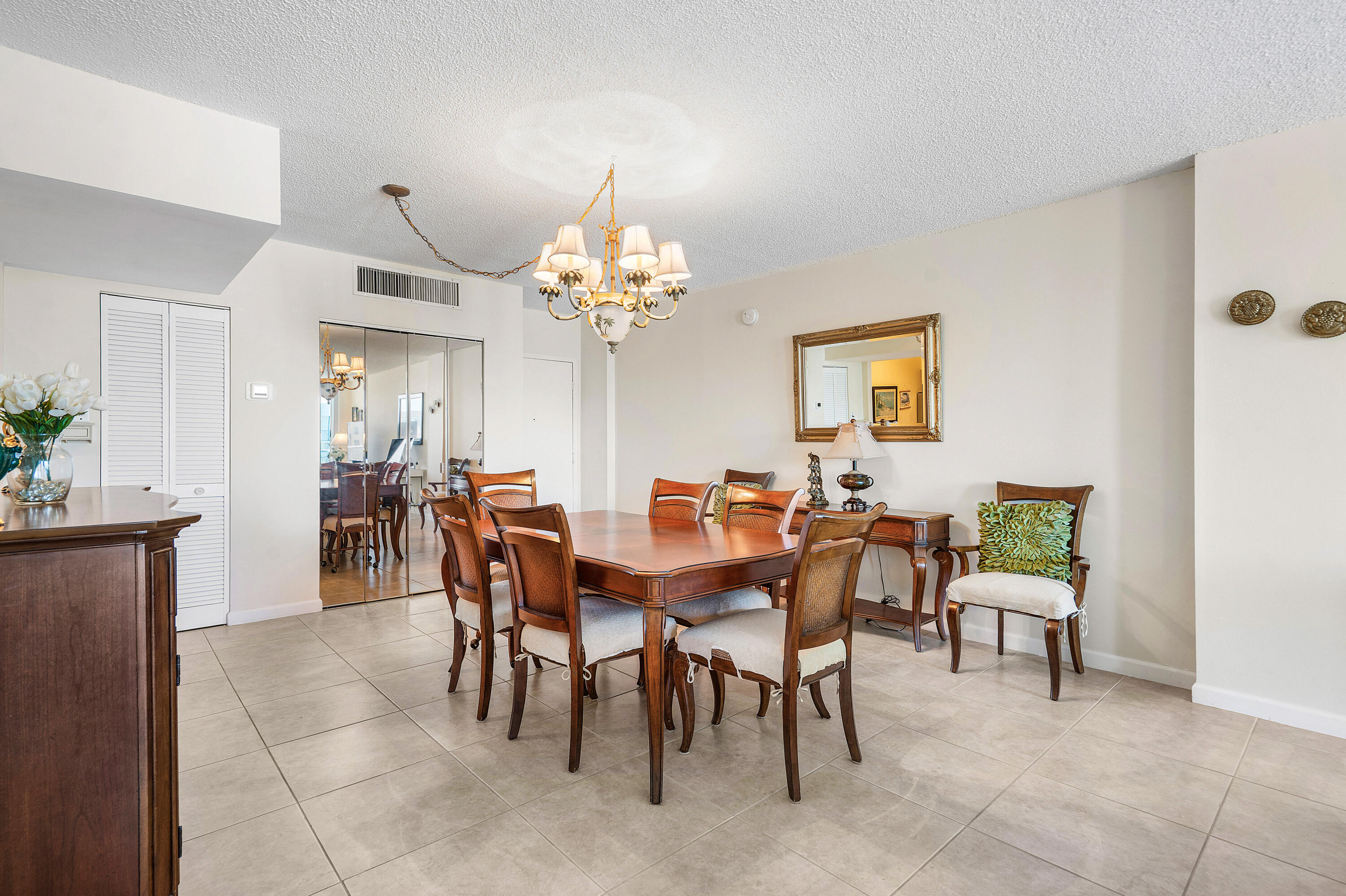 3450 South Ocean Boulevard, Unit 714 Palm Beach, FL 33480 - Photo 10 of 27 a view of a dining room with furniture and chandelier