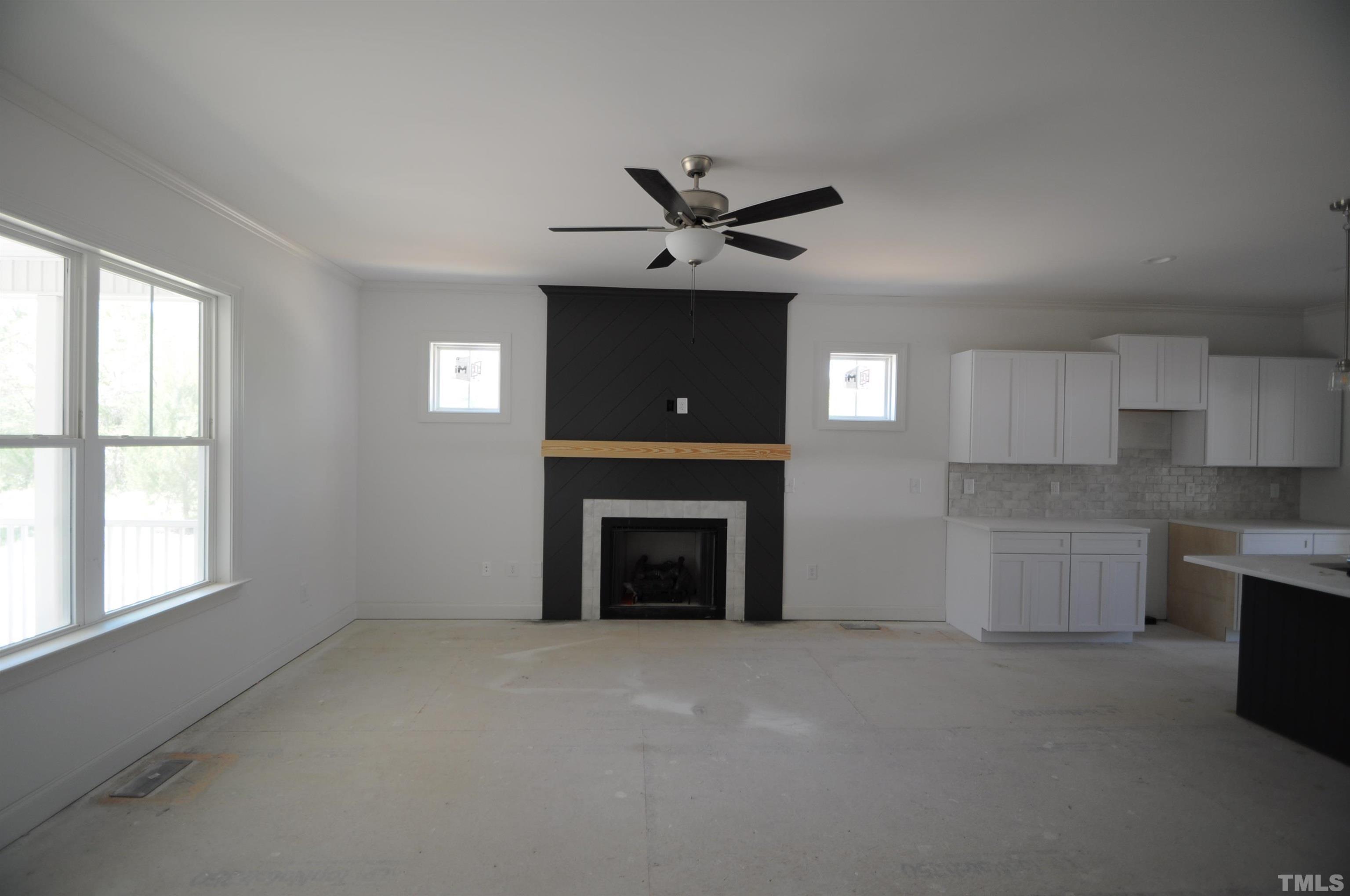 40 Pilot Ridge Road Zebulon, NC 27597 - Photo 4 of 11 an empty room with windows and a fireplace