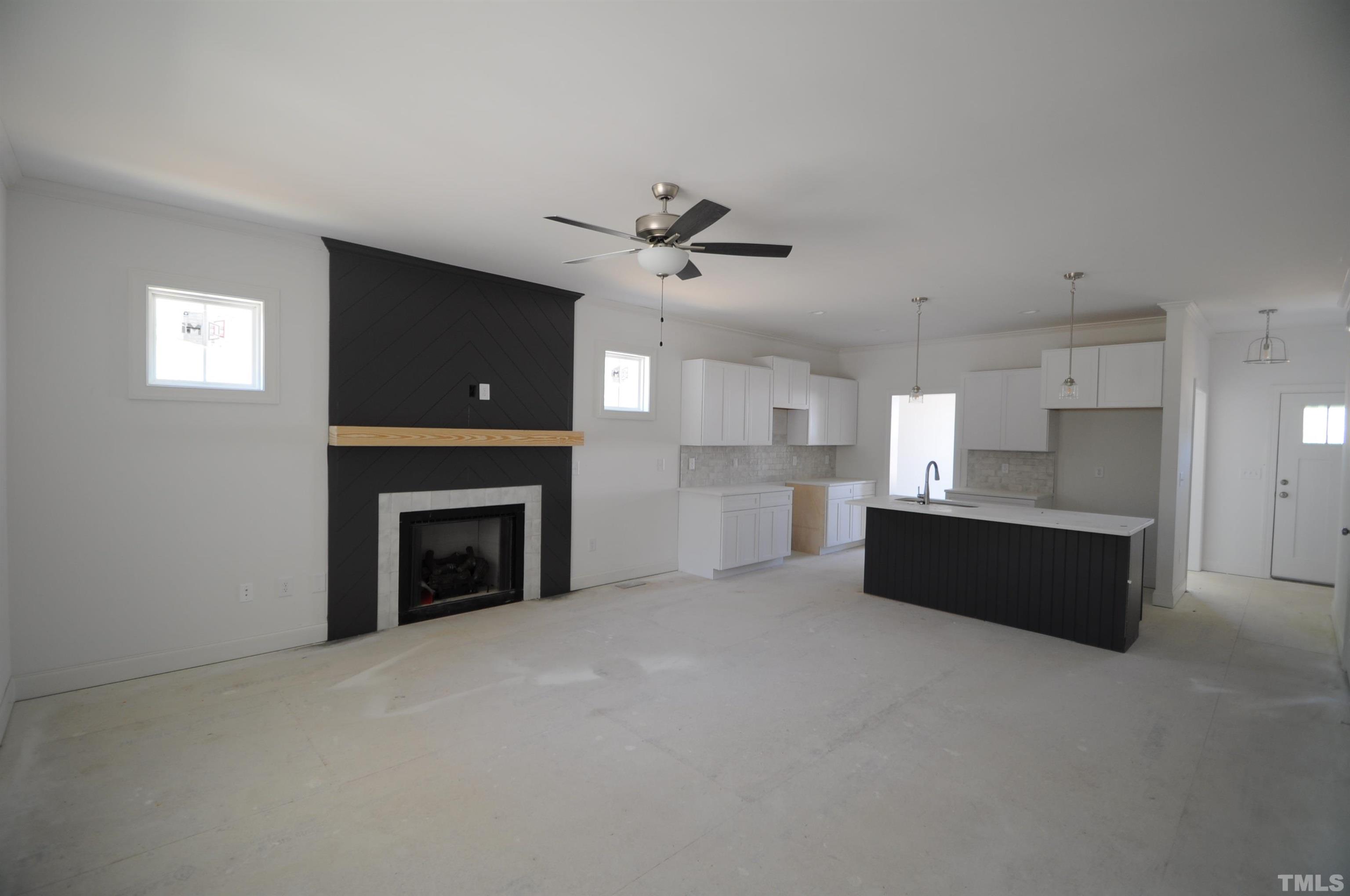 40 Pilot Ridge Road Zebulon, NC 27597 - Photo 5 of 11 a view of a kitchen with a sink and a fireplace