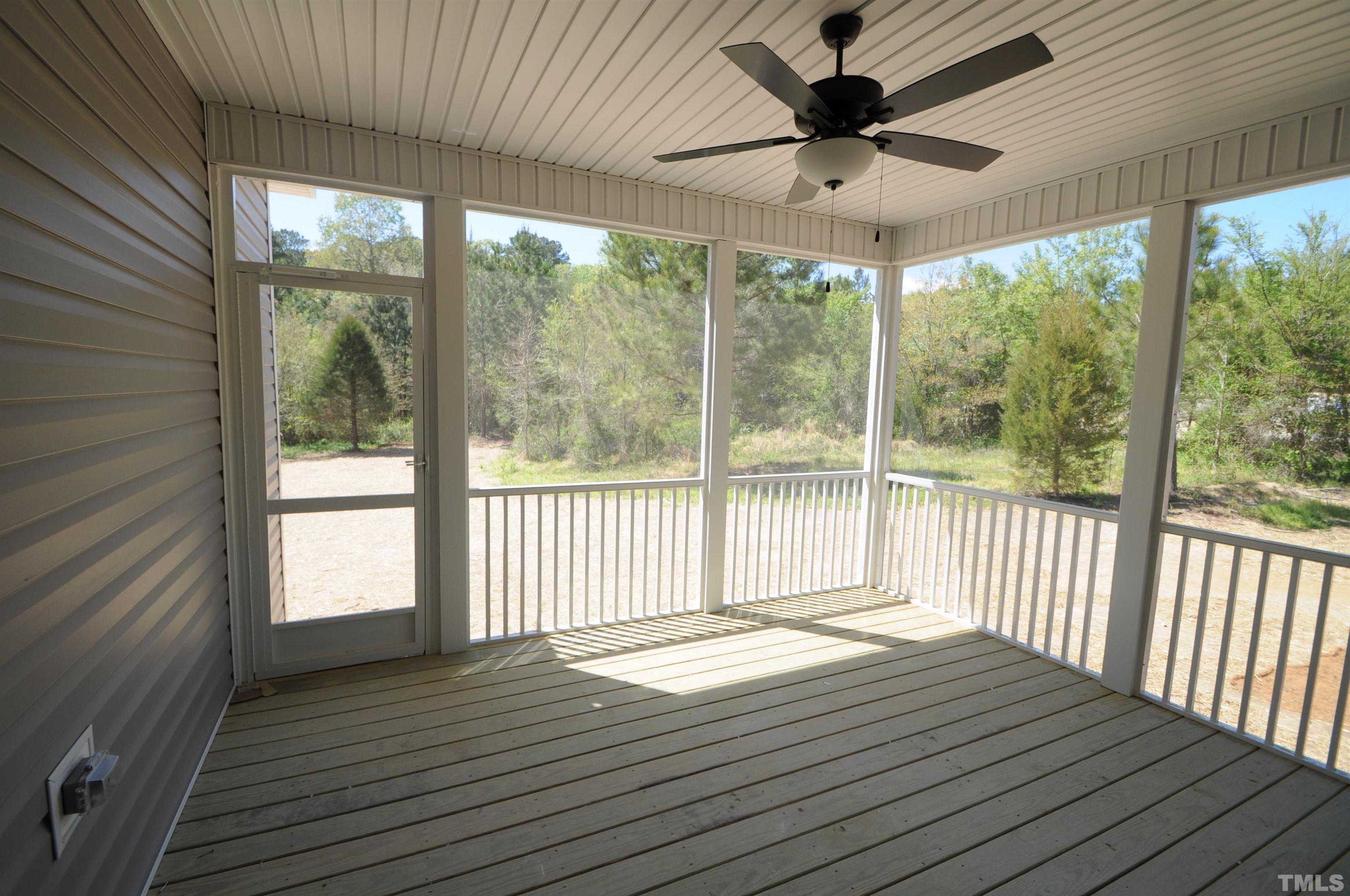 40 Pilot Ridge Road Zebulon, NC 27597 - Photo 10 of 11 a view of a livingroom with wooden floor and a ceiling fan