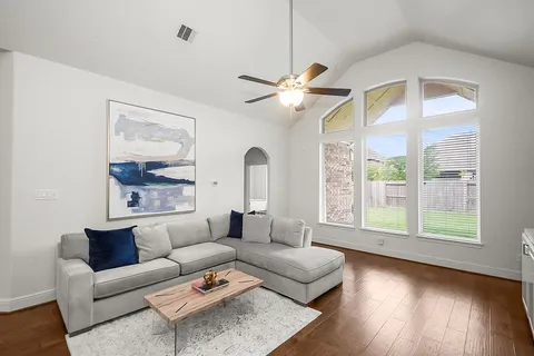 a kitchen with granite countertop attached living room