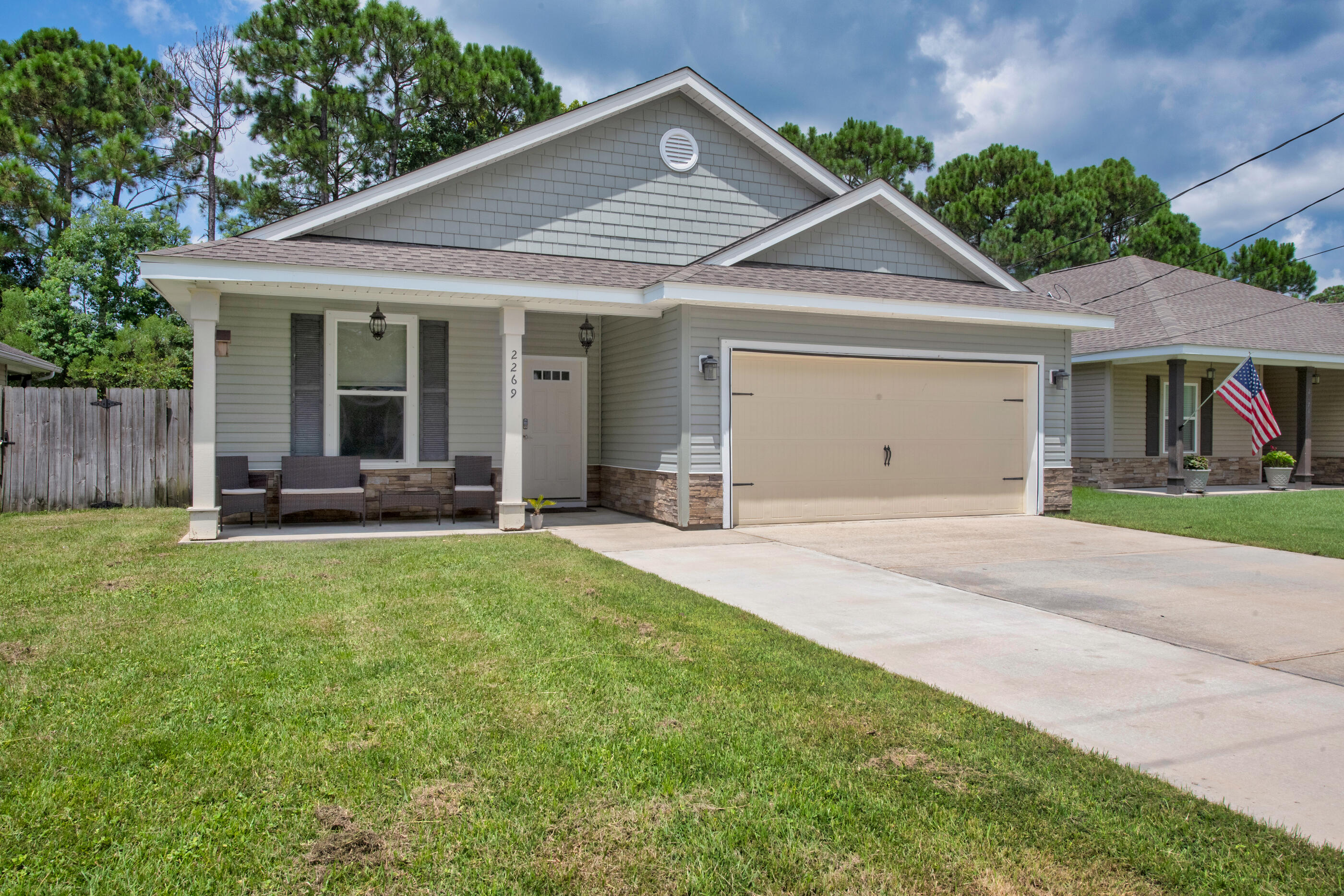 a front view of a house with a yard and porch