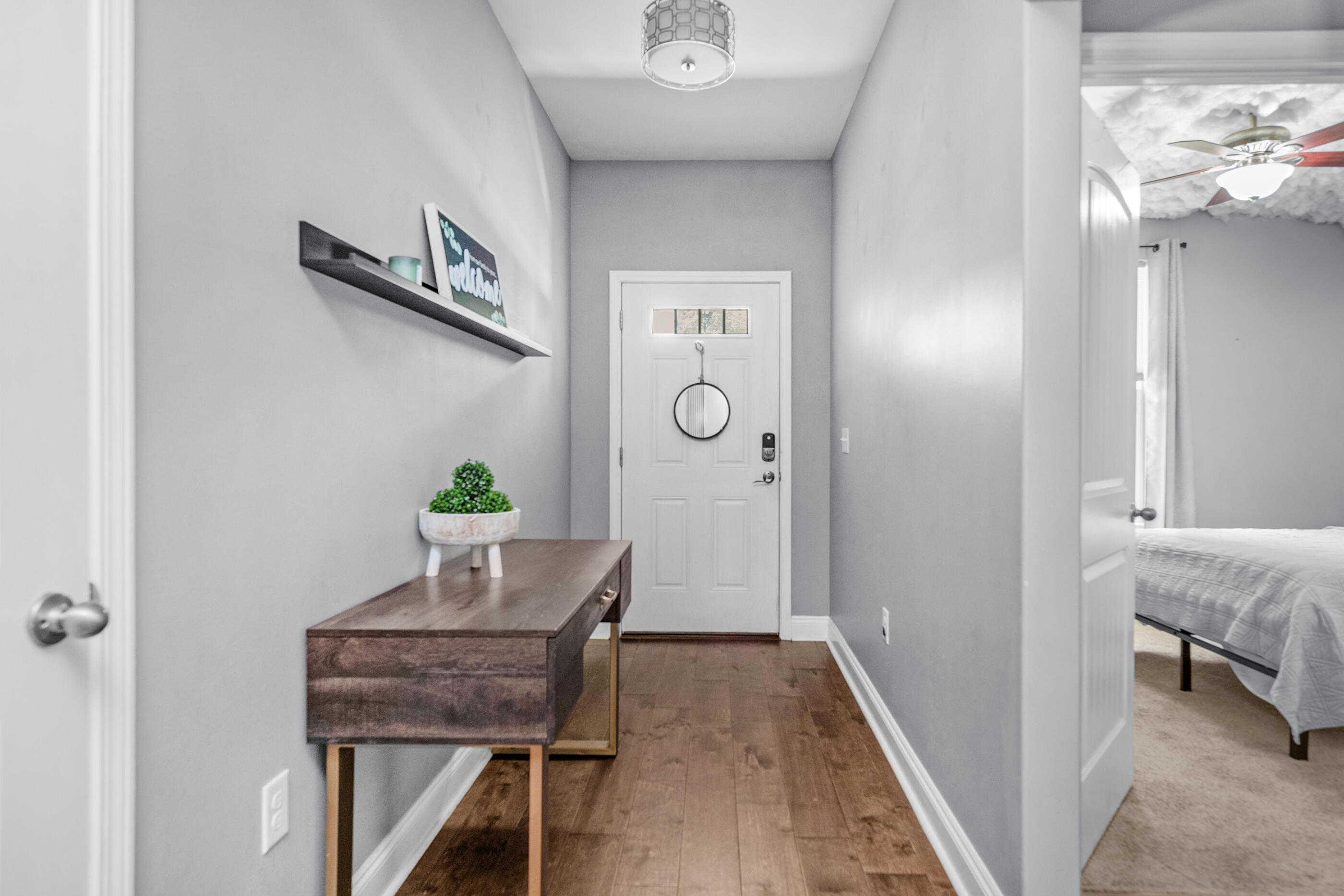 2269 Tom Street Navarre, FL 32566 - Photo 2 of 40 a workspace with furniture and wooden floor