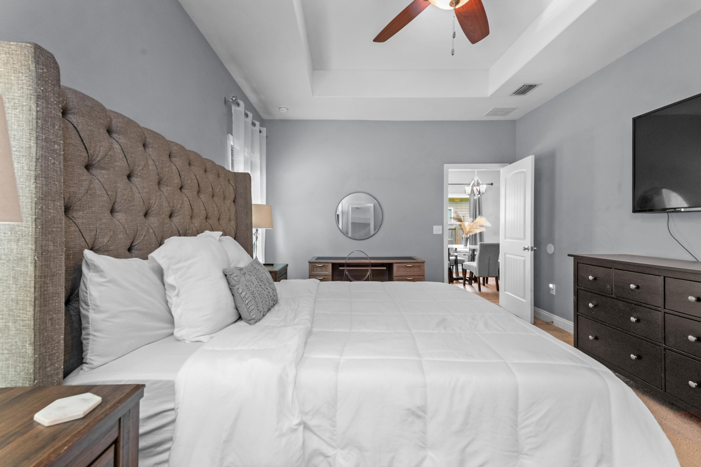 2269 Tom Street Navarre, FL 32566 - Photo 30 of 40 a bedroom with a bed and a flat tv screen on dresser