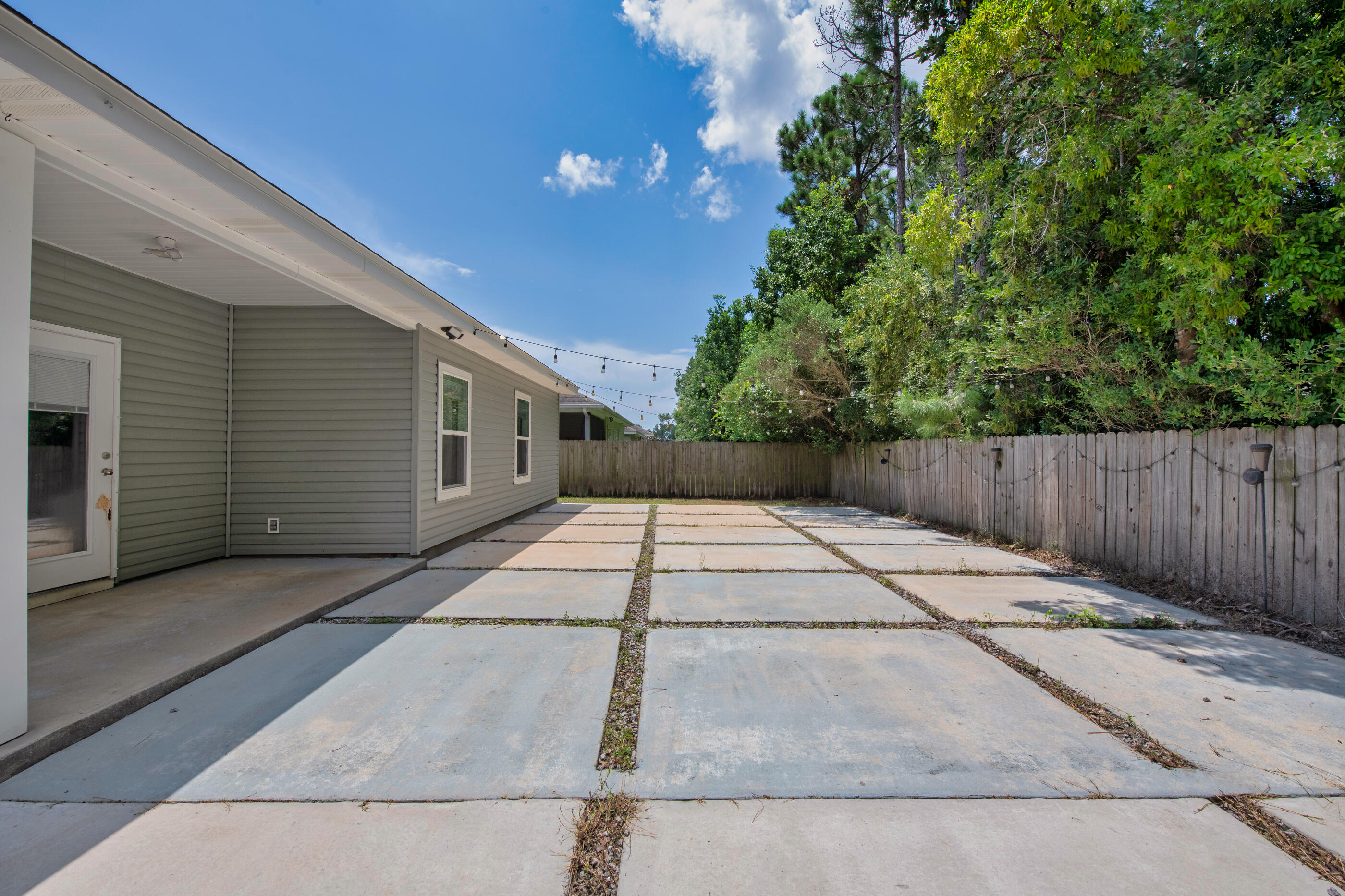 2269 Tom Street Navarre, FL 32566 - Photo 35 of 40 a backyard of a house with wooden floor
