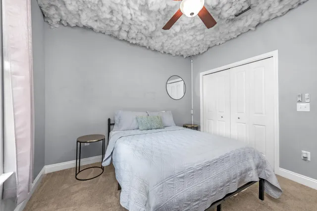 a bedroom with a bed and a chandelier