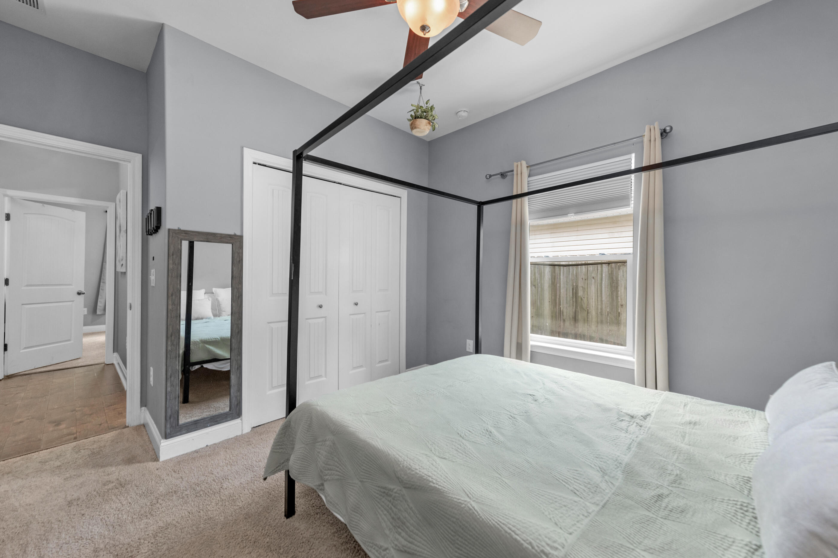 2269 Tom Street Navarre, FL 32566 - Photo 9 of 40 a bedroom with a bed and sliding door