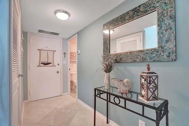 a view of a livingroom with wooden floor and a kitchen view