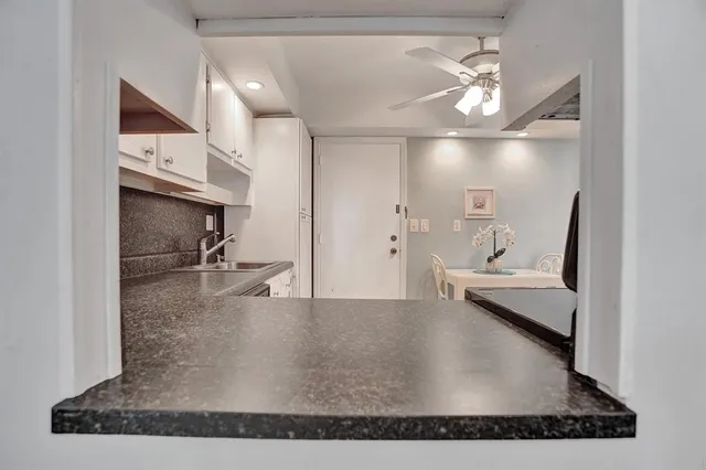 a view of a hallway with a couch and chandelier
