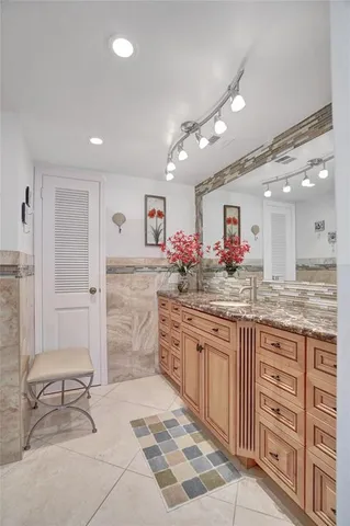 a kitchen with granite countertop a sink and cabinets