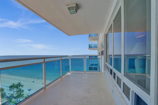 a spacious bedroom with a large bed and a chandelier