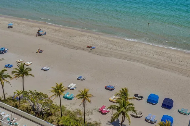 a view of kitchen with sink refrigerator dining table and chairs