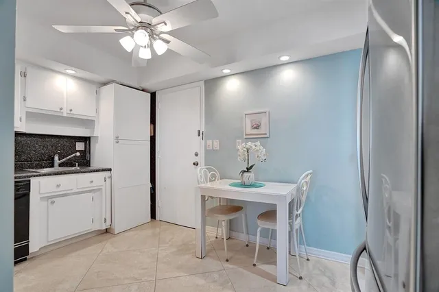 a view of a dining room with furniture a chandelier and wooden floor